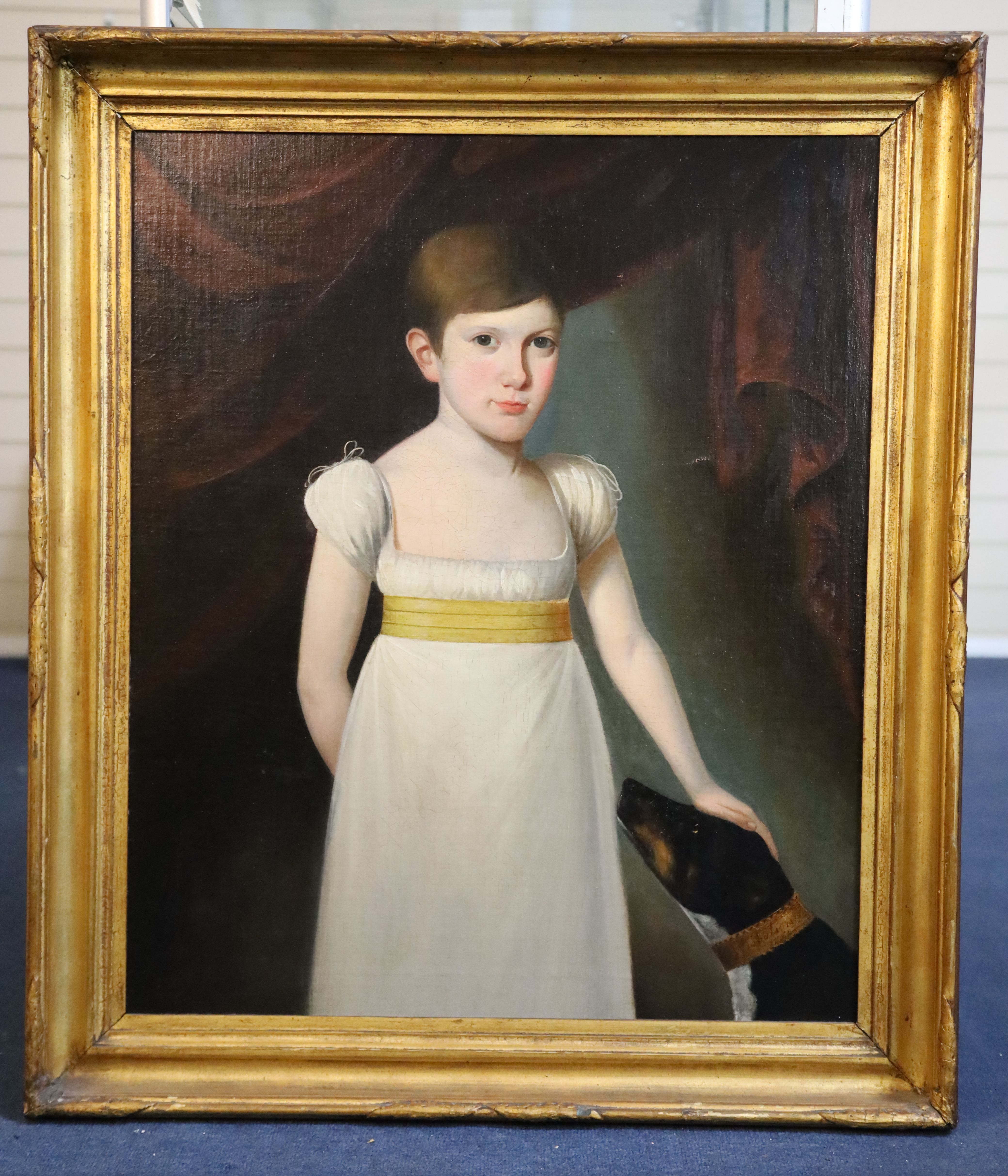 Early 19th century English School Half length portrait of a youth standing with his hand resting upon a dogs head 28.5 x 24in.